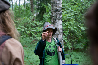 Tuomas teaching about mushrooms in the forest