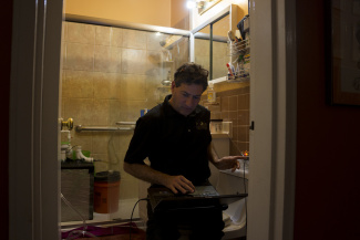 A professor checking his invention at the bath room A professor checking his invention at the bath room
