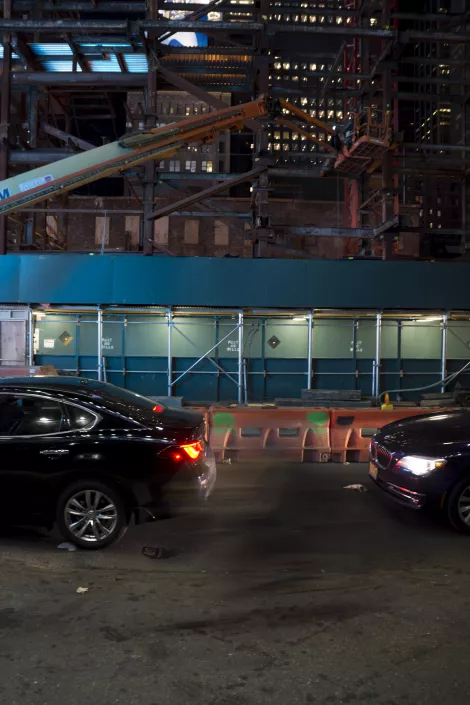 Cars passing by at the streets of New York while they vanish into thin air.