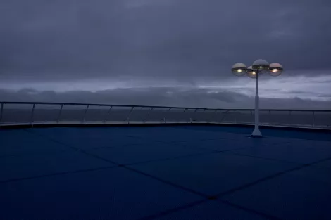 The stern of a ferry after sundown