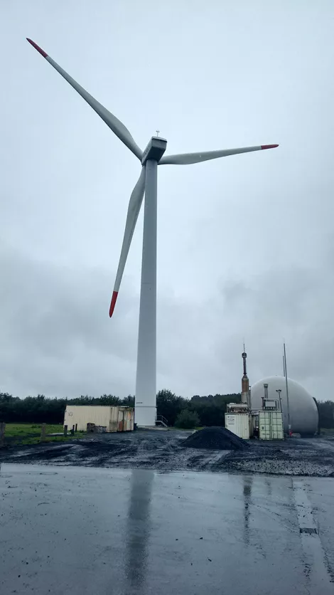 A wind turbine at a biogas plant